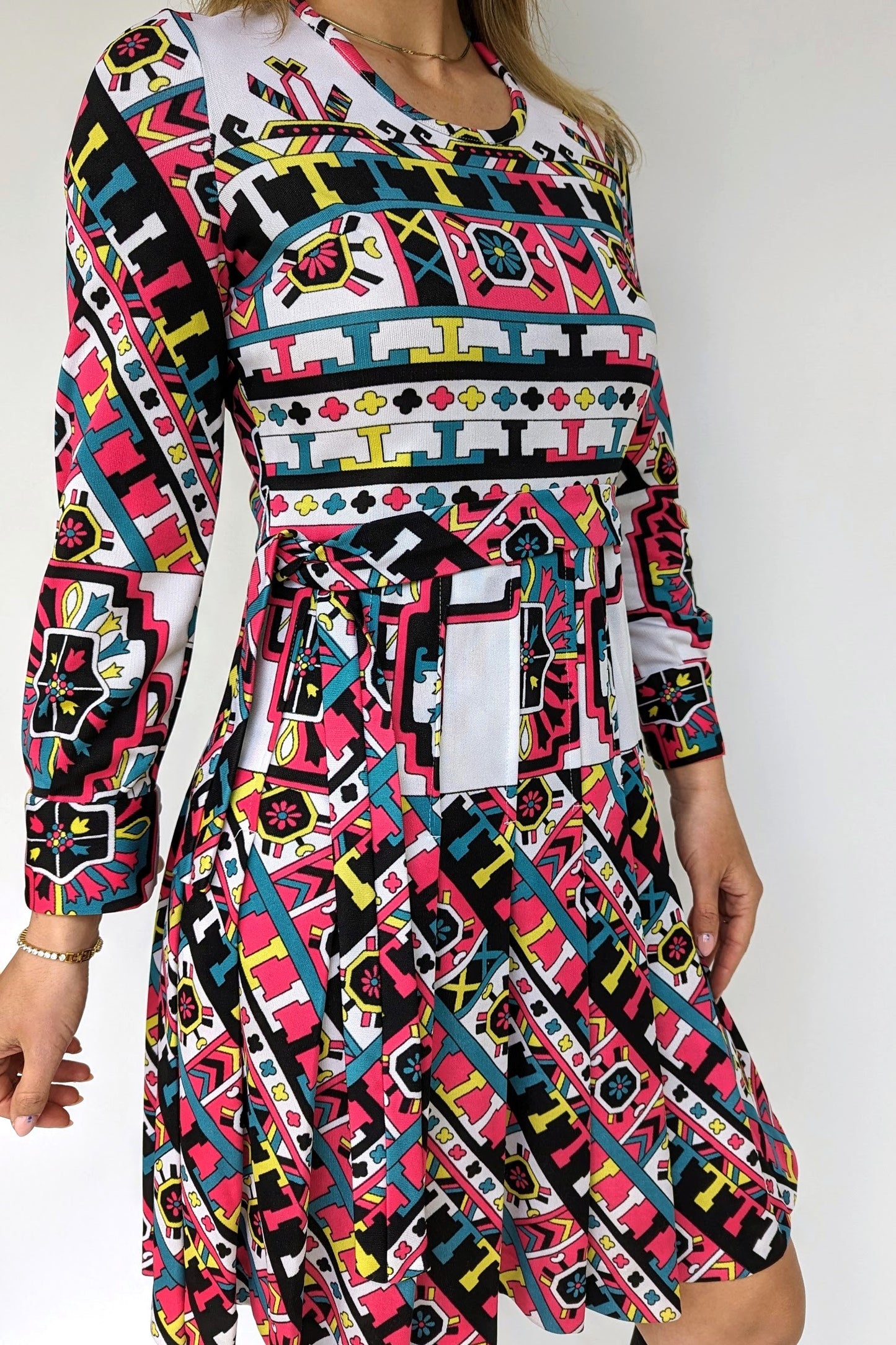 1970s patterned dress with belt and pleats in what, black, pink and turquoise geometrics pattern and belt