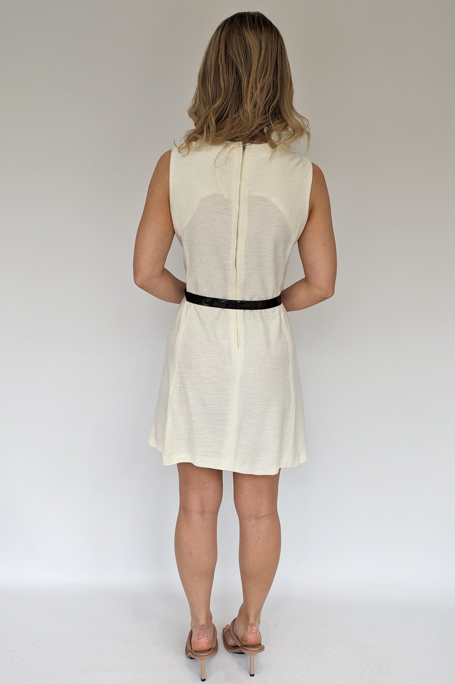 back view of side view of mod 60s cream jersey dress with decorative black buttons and patent belt