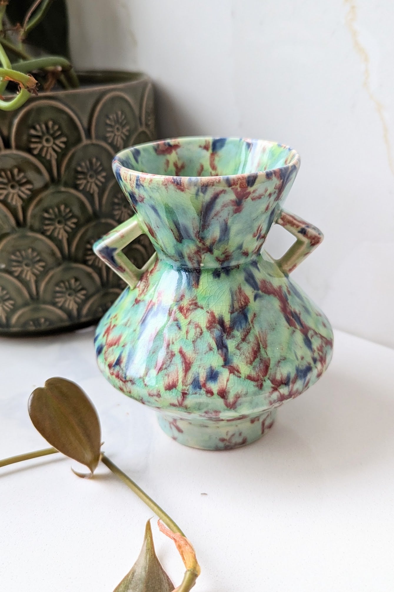 front of turquoise marbled blue art deco vase