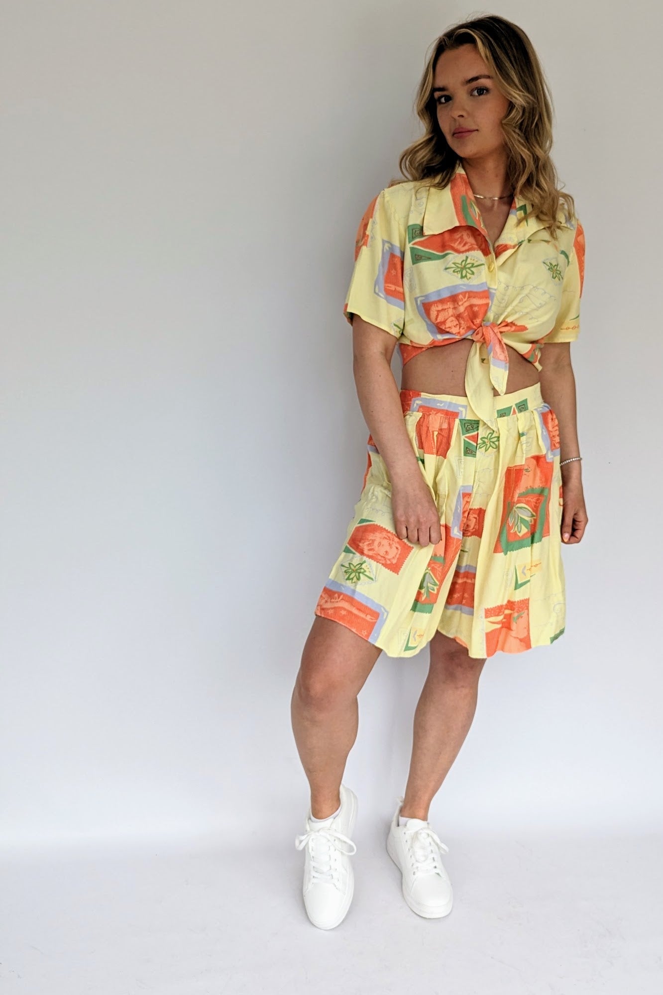 vintage 1980s yellow and orange co-ordinate set with shorts and a tie blouse
