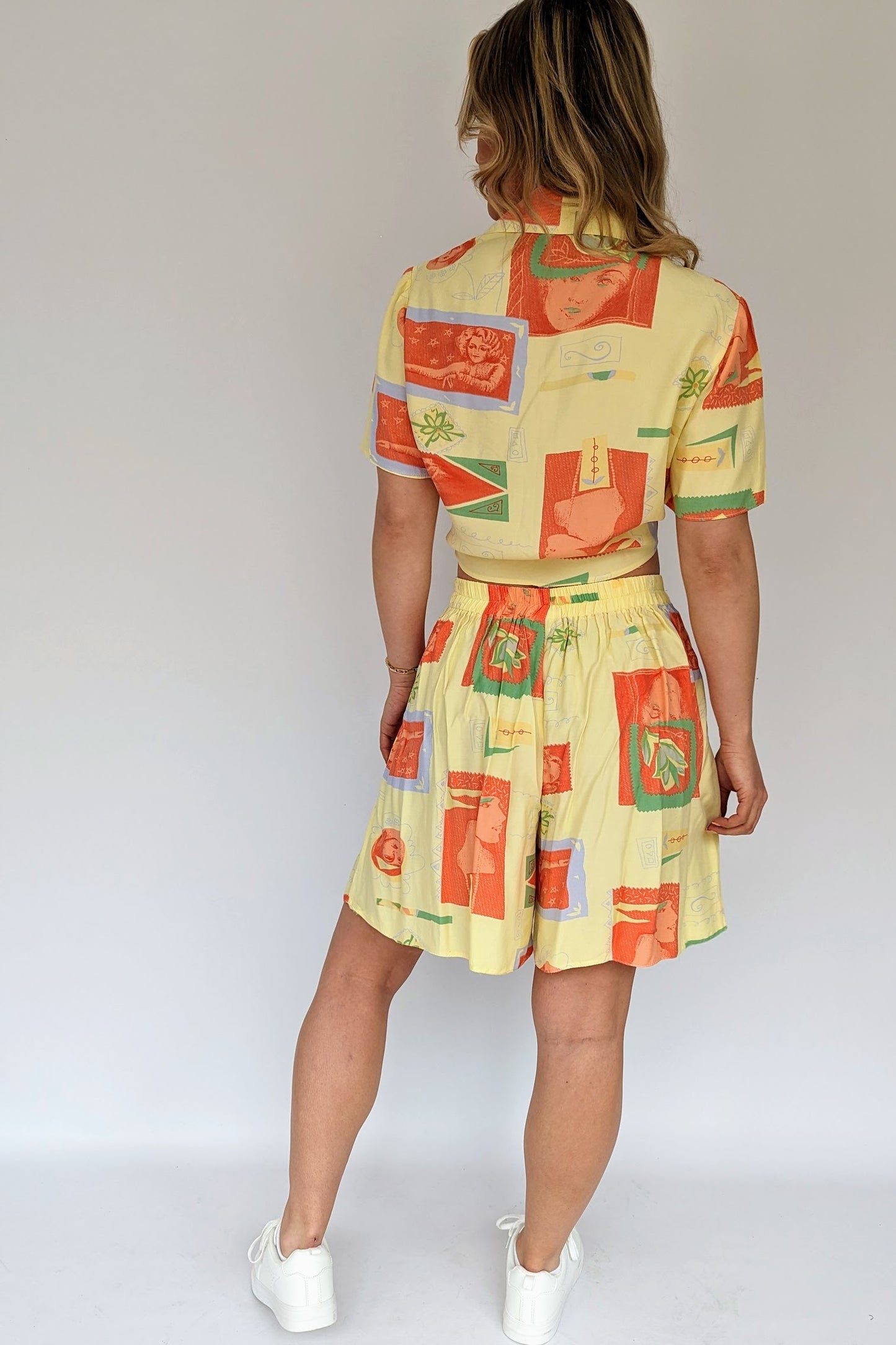 back of vintage 80s yellow and orange co-ordinate set with shorts and a tie blouse