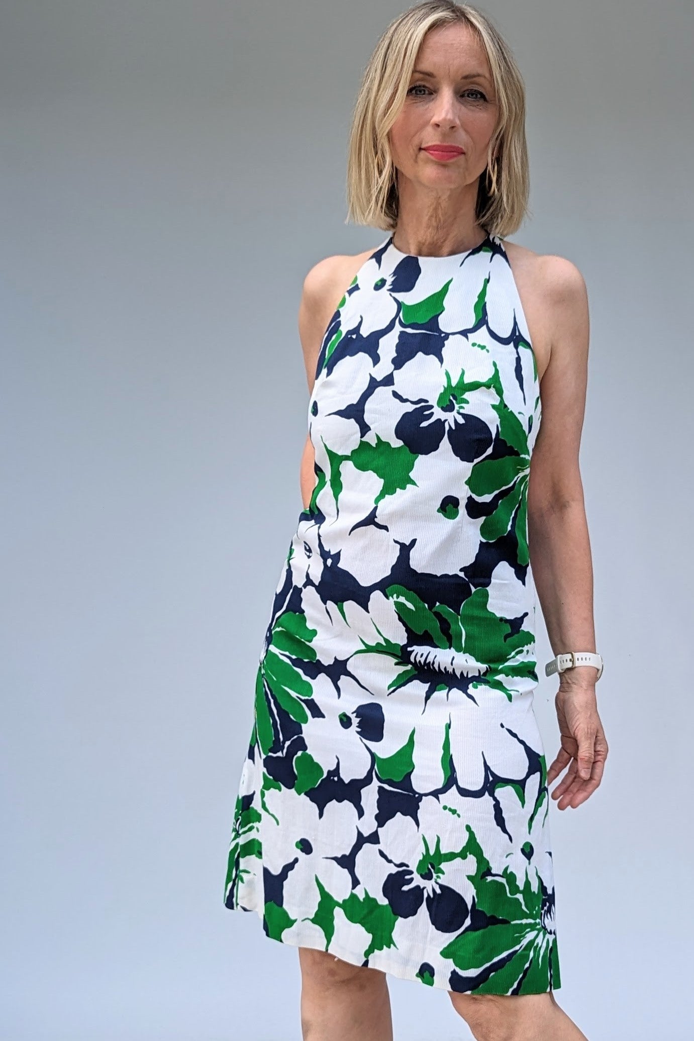 Close up of vintage halterneck dress in green, blue and white floral pattern