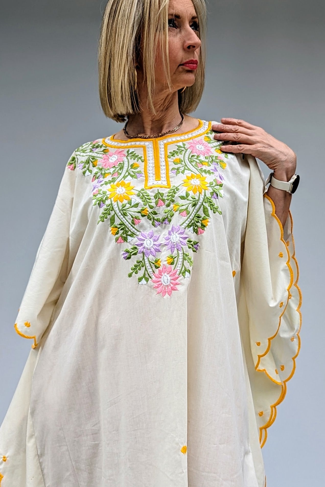 top of vintage cream kaftan with embroidered flowers in yellow, green, pink and lilac