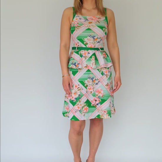 video clip of tropical patterned peplum dress with green belt in white, green and pink