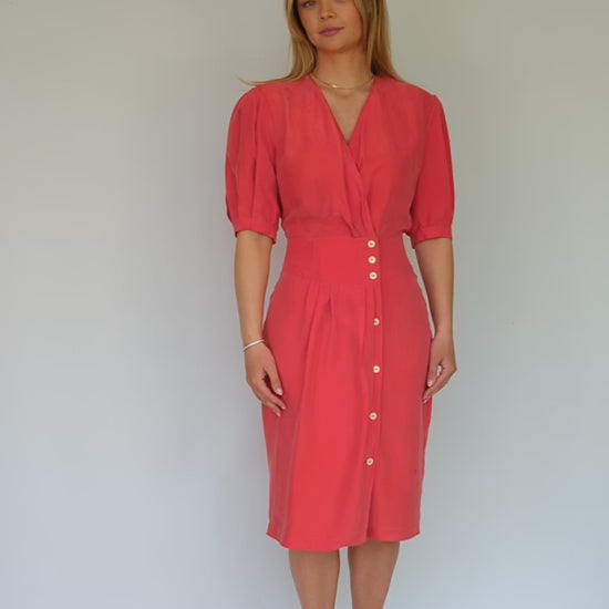 video showing 80s vintage red silk red dress with wrap front and pleated shoulders