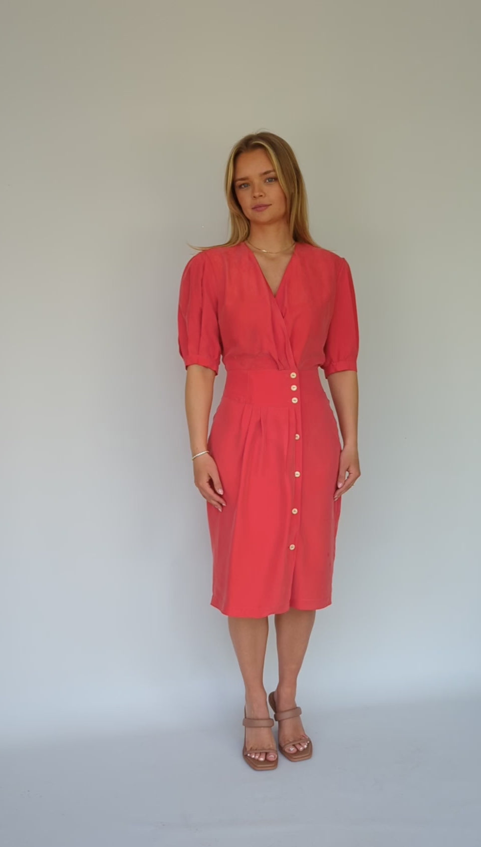 video showing 80s vintage red silk red dress with wrap front and pleated shoulders
