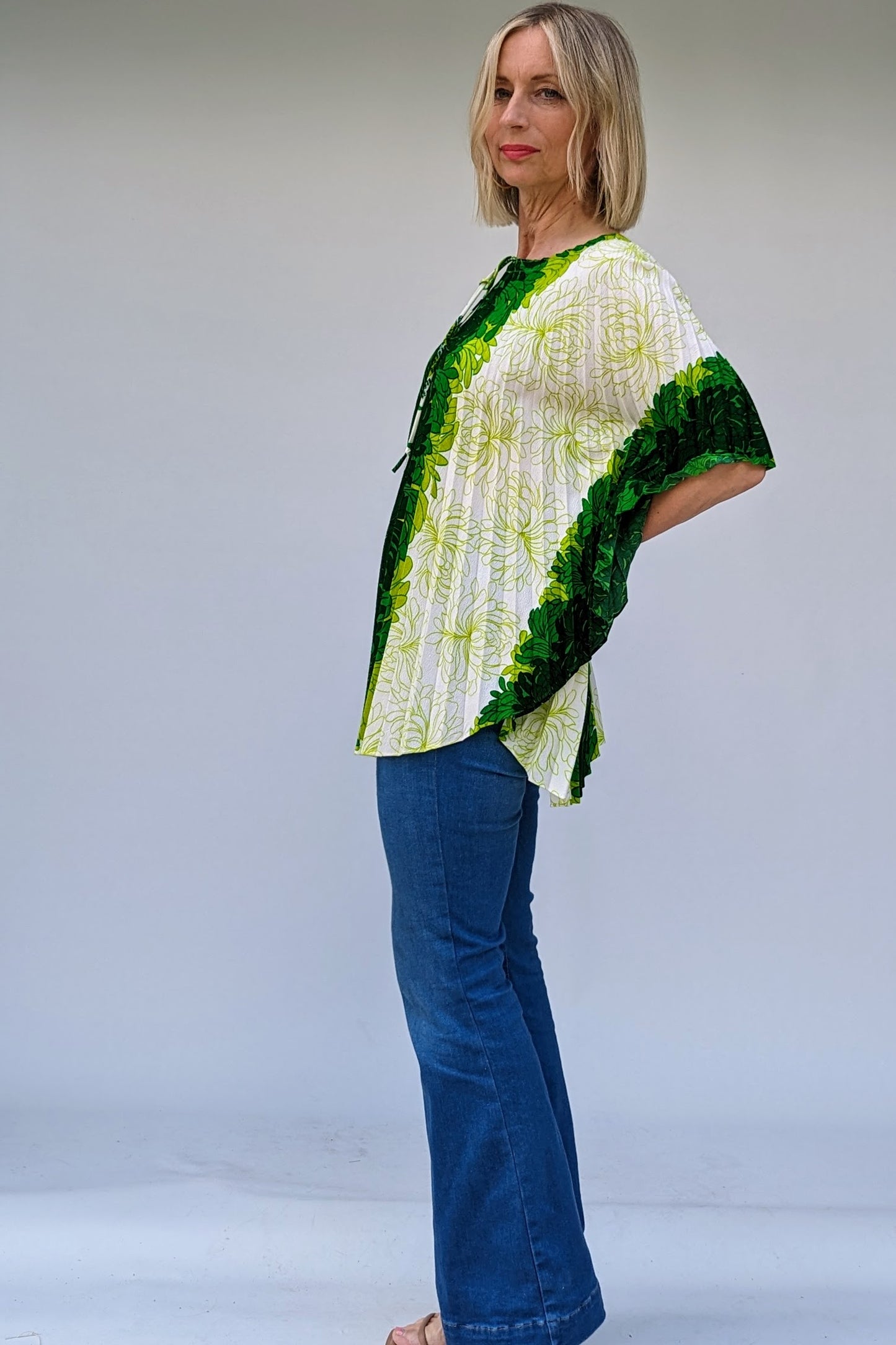 side of green and white floral design pleated 60s vintage beach ware top