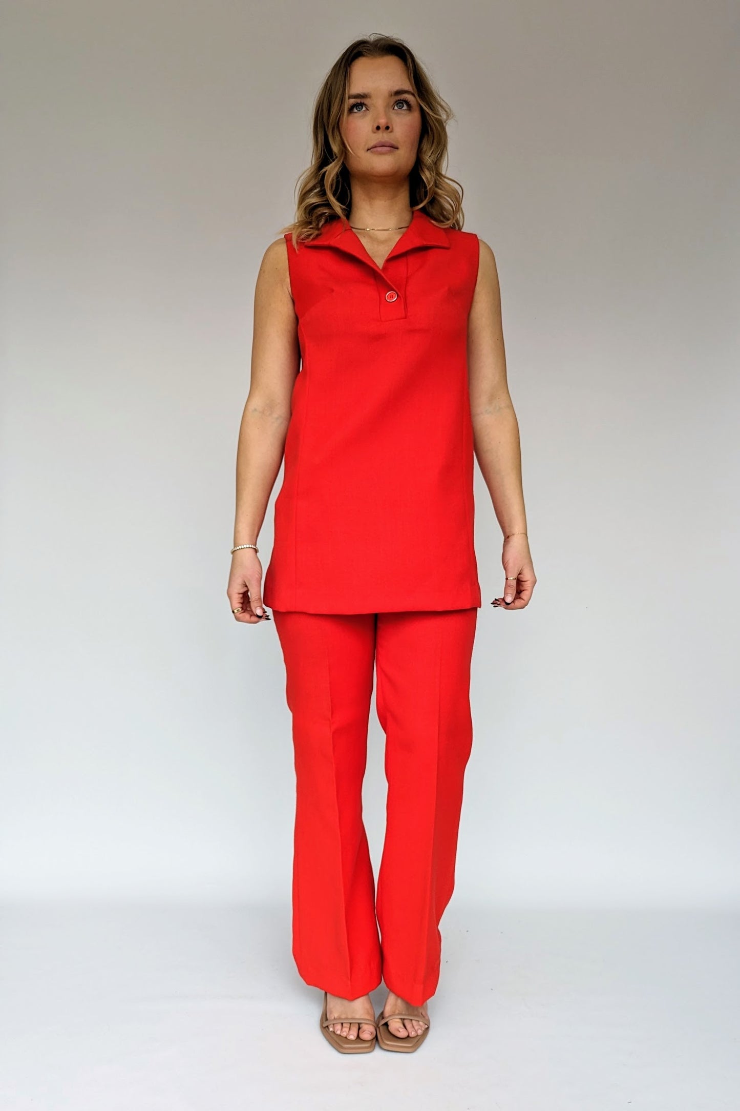 red co-ord set with sleeveless collared top and flare trousers
