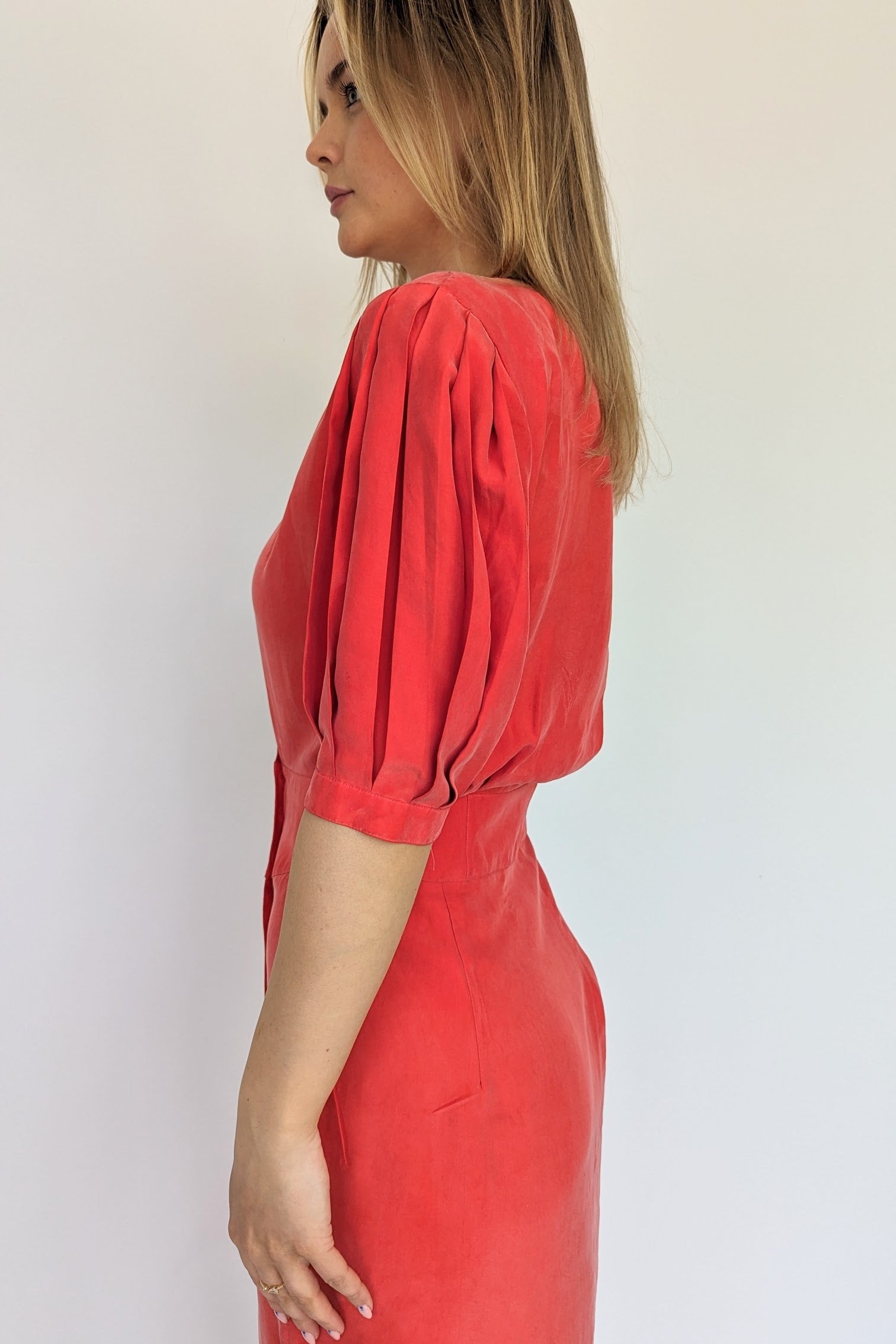 side of red vintage silk dress showing puff pleated sleeves