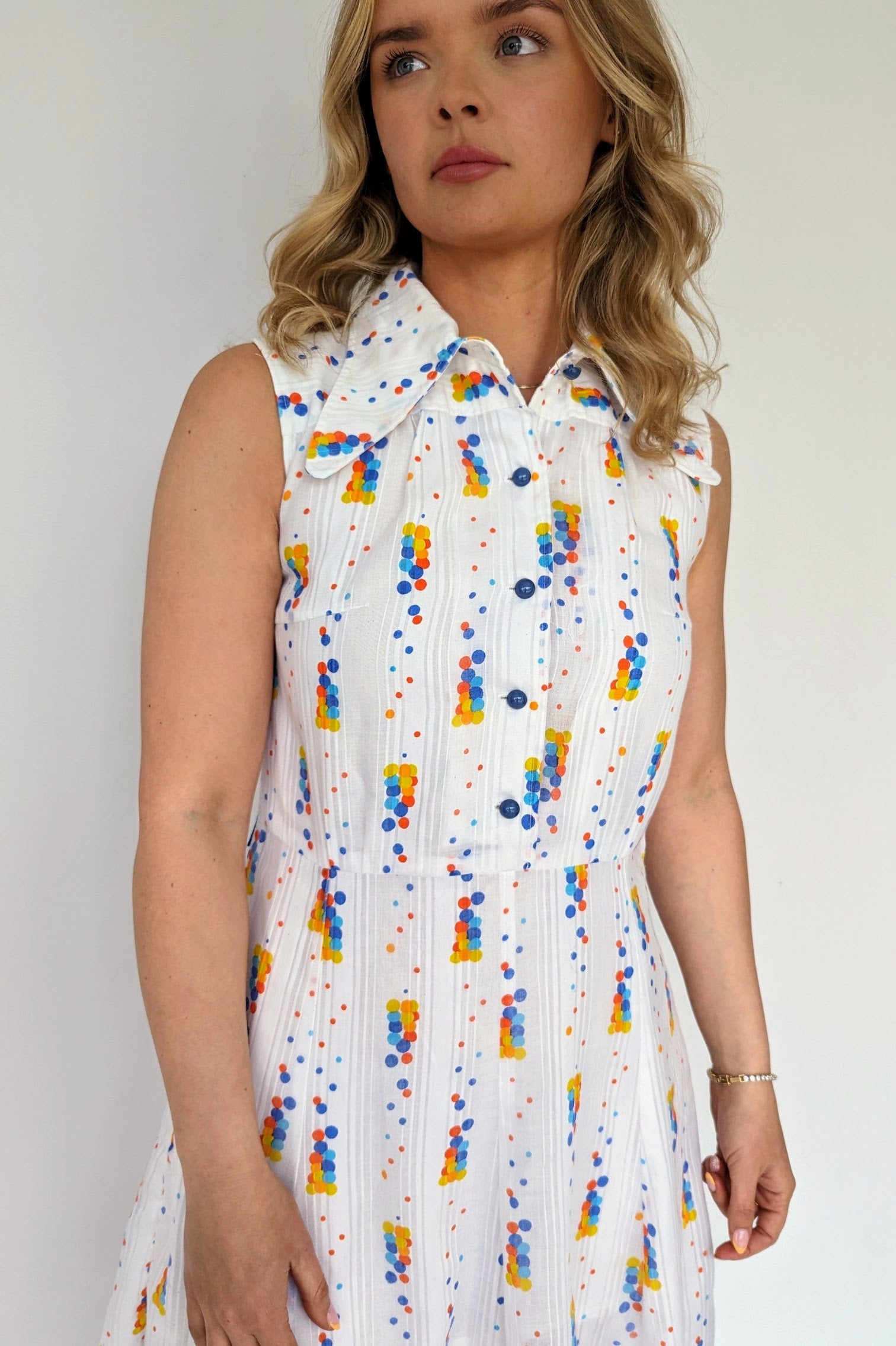 front of vintage 60s mini dress white with coloured spots and dagger collar