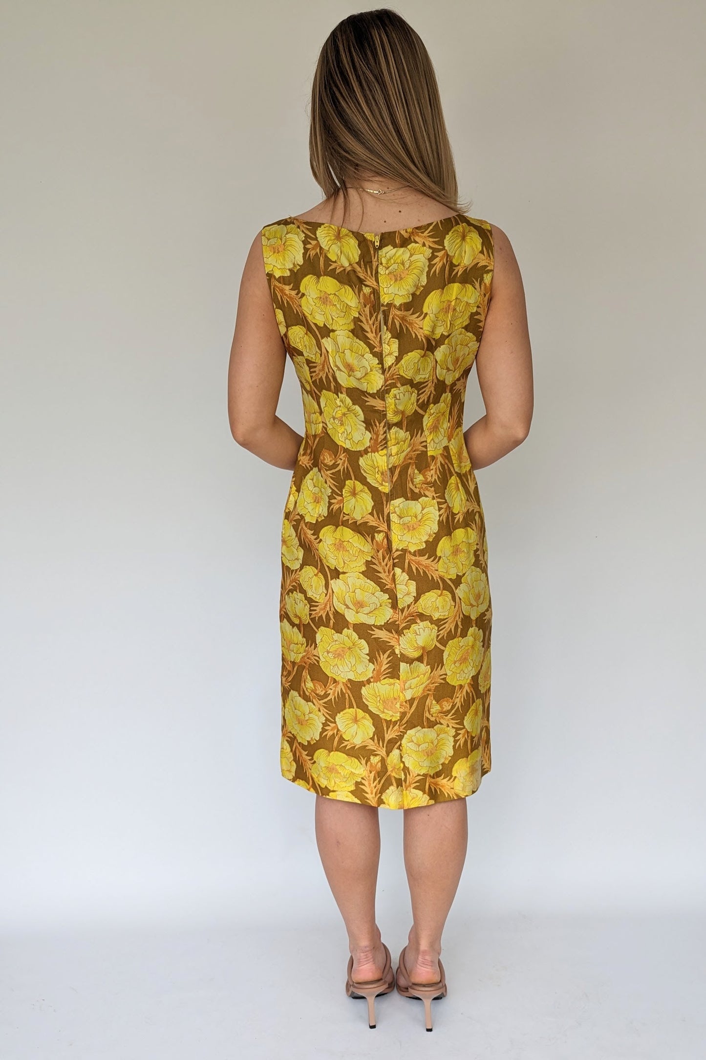back of 1960s brown and yellow floral shift wiggle dress with empire line and bow