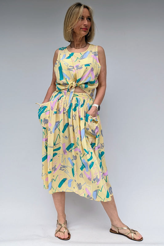 pastel coloured two piece co-ord set with skirt and sleeveless tie top with pockets