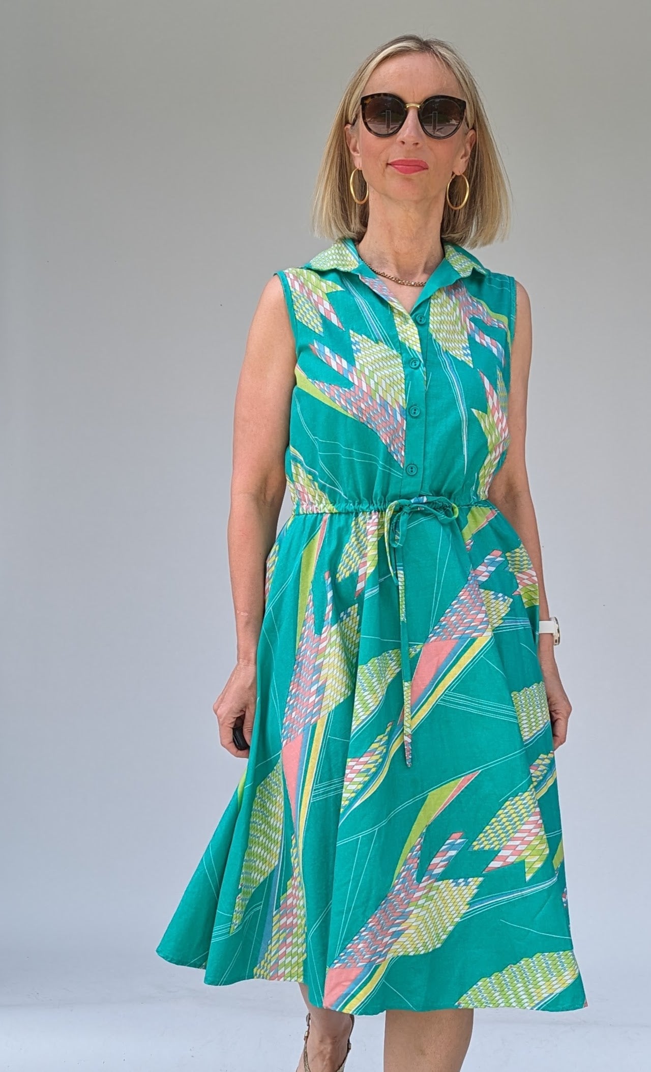 front of Vintage cotton summer tea dress in turquoise with a geometric pattern in pastels