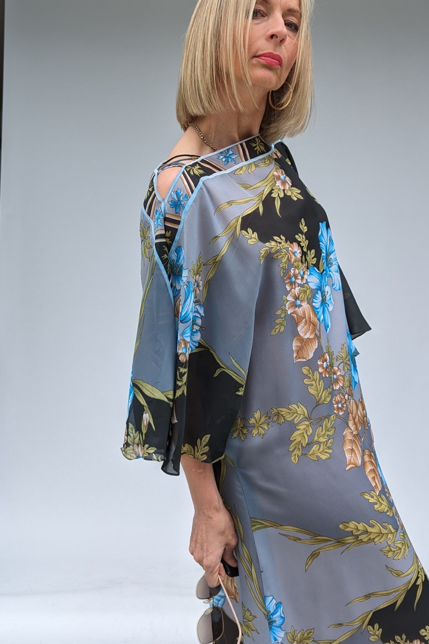 should straps on the boat neck of the Long bat sleeved vintage floral kaftan in grey, black, blue and brown with a sheer overlay and a dusky peach lining