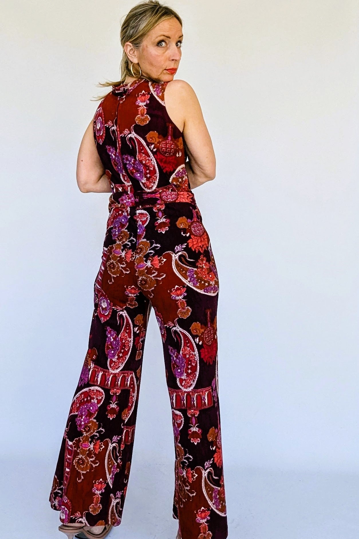 70s retro jumpsuit in maroons, oranges and pinks
