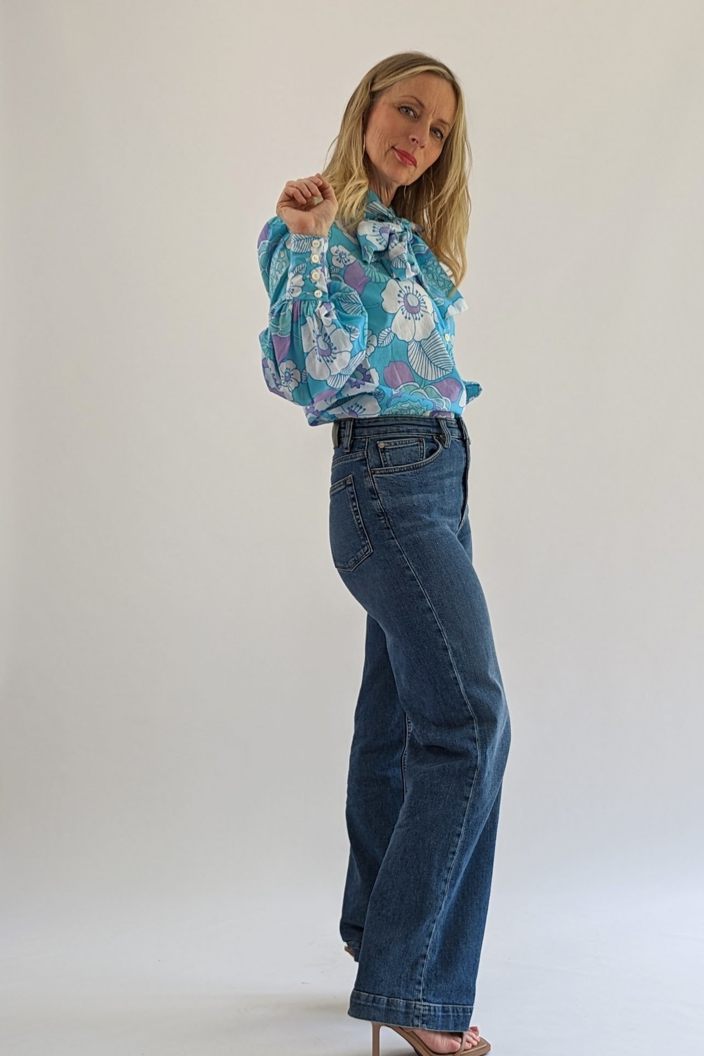 side view of Floral vintage blue tie neck blouse with long sleeves