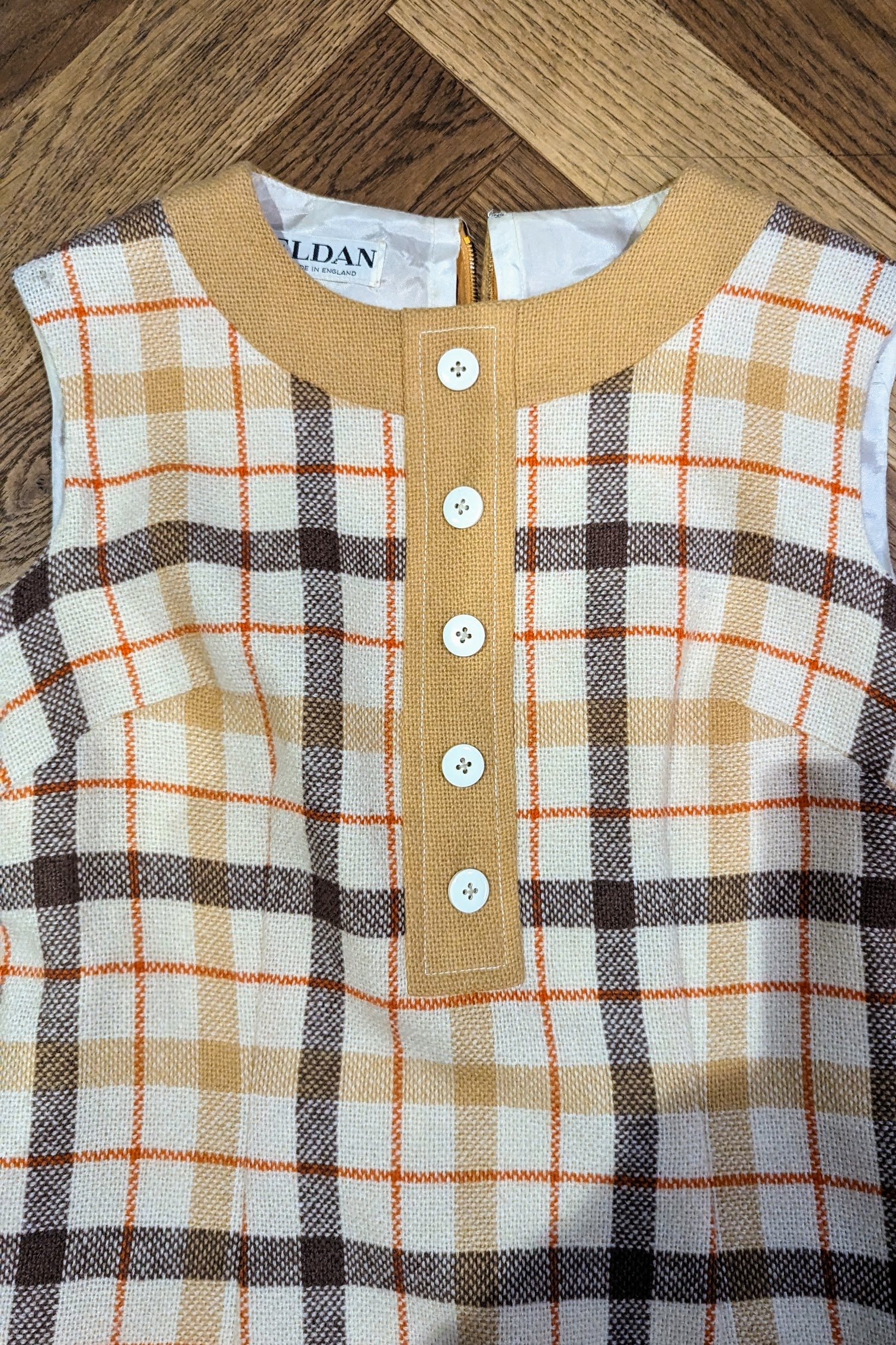 wear to material on shoulder of checked dress