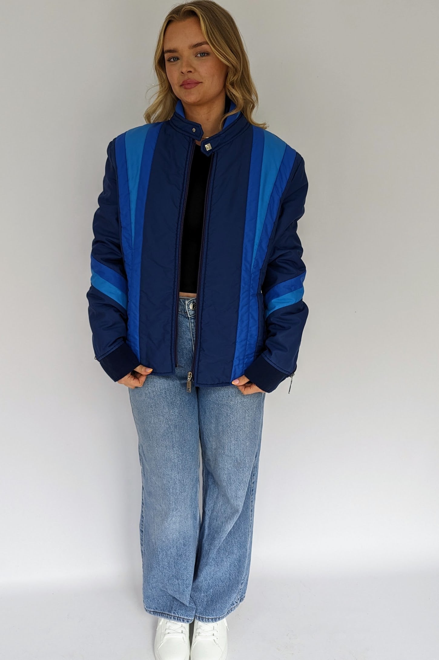 front of vintage blue puffer ski jacket with different tones of blue stripes on front, sleeves and neck