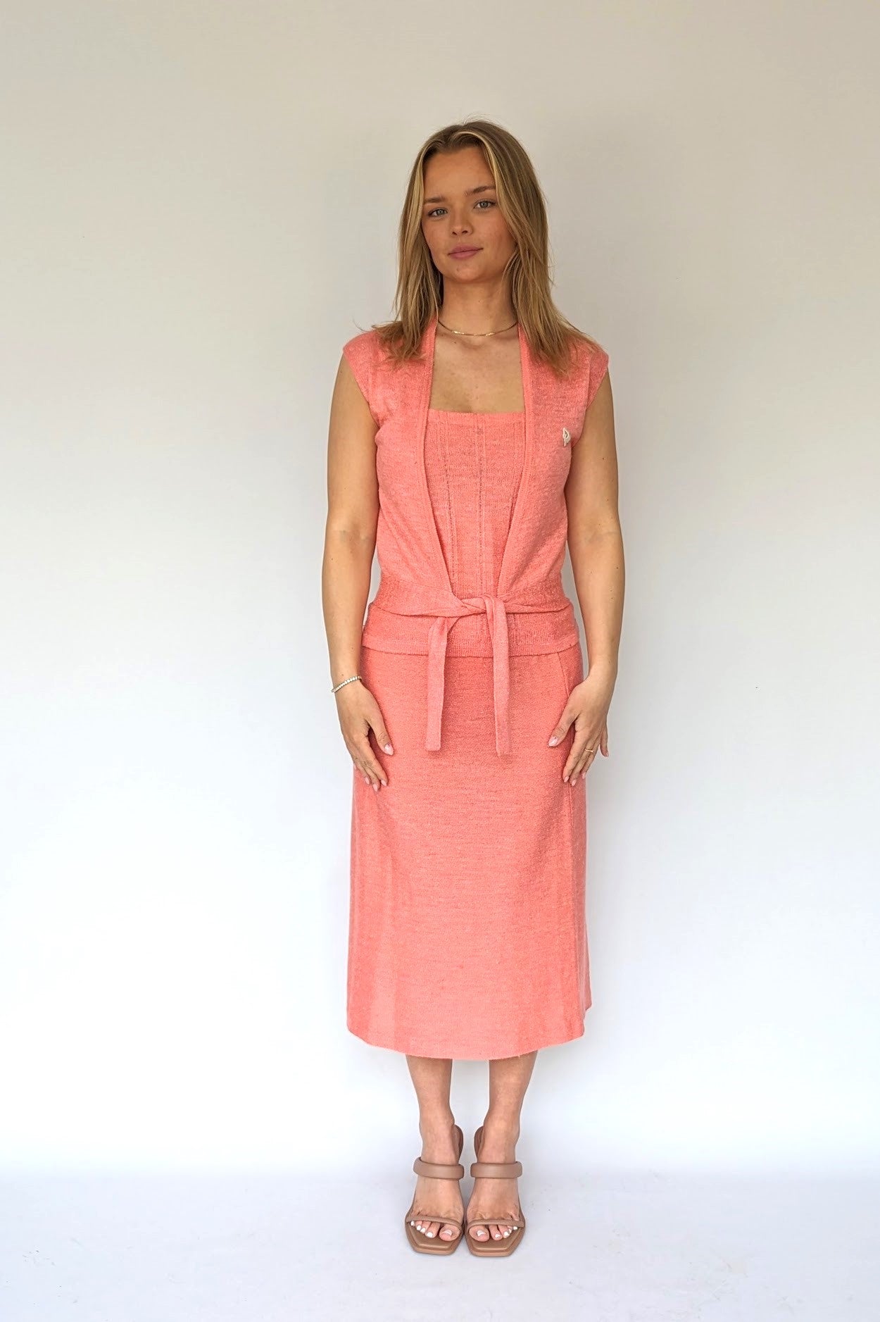 Vintage Christian Dior Co-Ord set in a soft knitted like material in peach with a skirt, top and sleeveless tie cardigan
