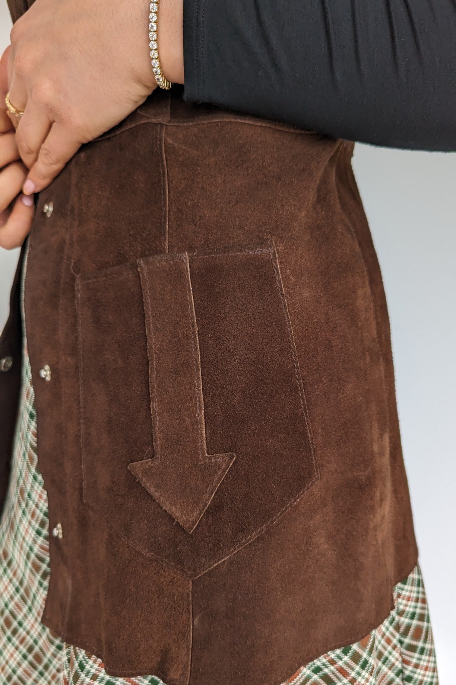 arrow on pocket of suede waistcoat