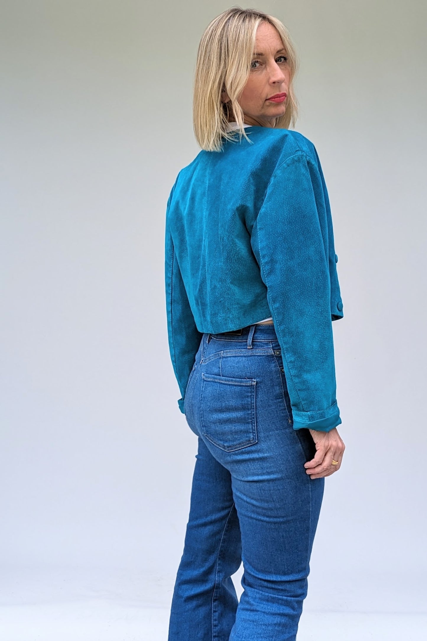 back of 80s Turquoise Suede Cropped Jacket vintage with poppers vintage