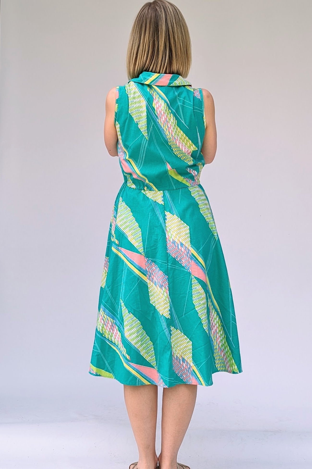 back of Vintage cotton summer tea dress in turquoise with a geometric pattern in pastels