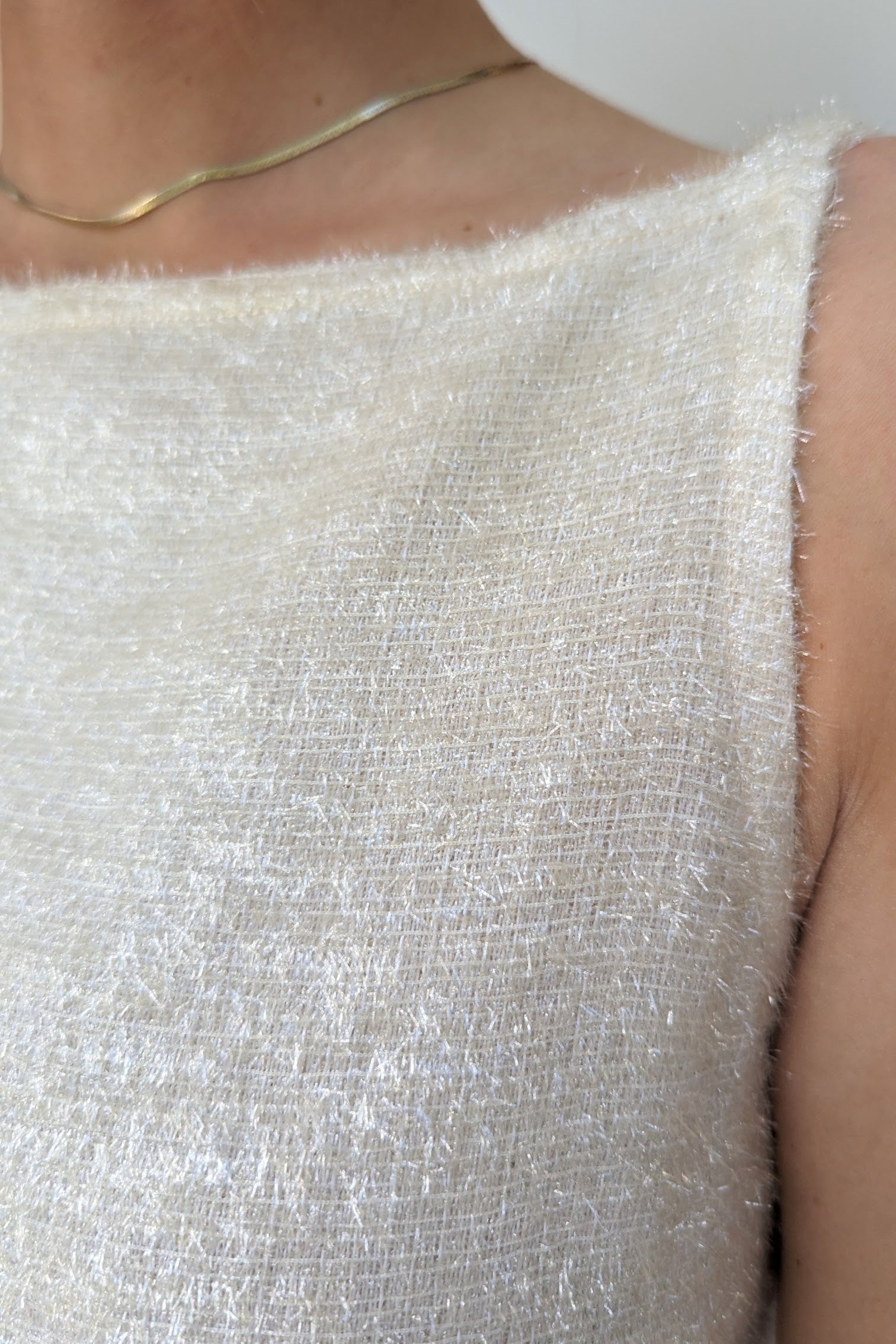 close up of fabric on white alberta ferretti short fitted evening dress in a sparkly tinsel like fabric