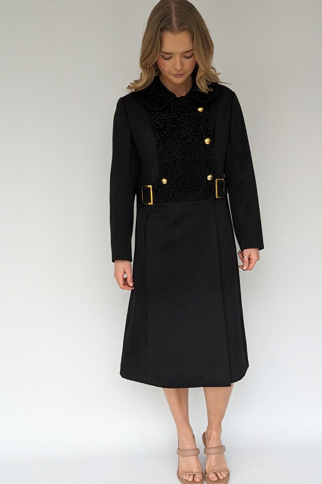 front of 1960s black vintage wool coat with gold buttons and buckles
