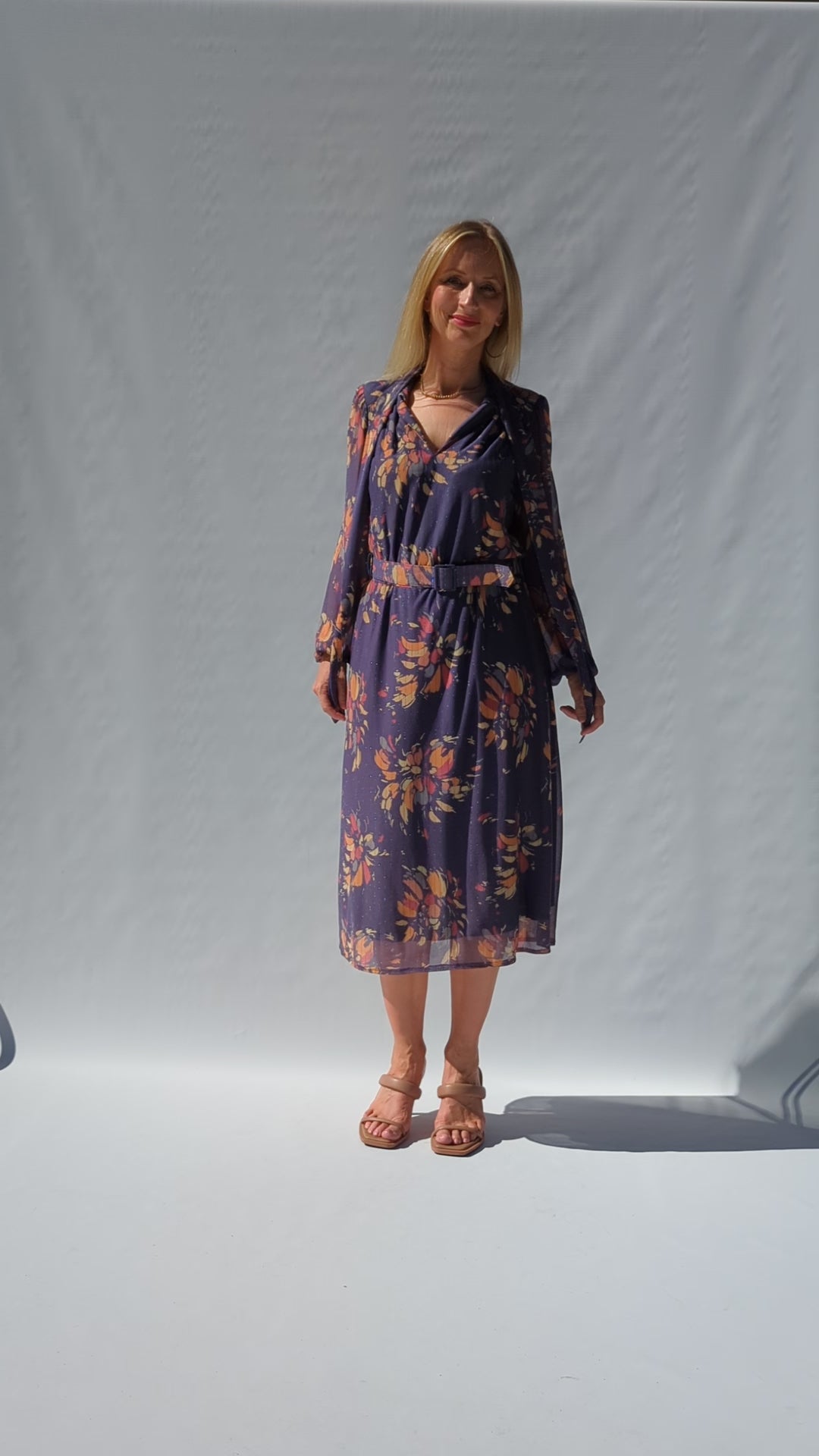 video showing vintage floral 80s dress in mauve with an abstract floral pattern of peaches and lilac