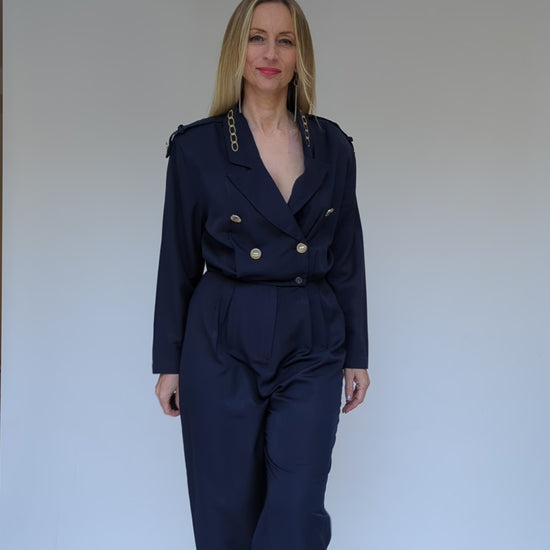 Navy jumpsuit with gold buttons and long sleeves