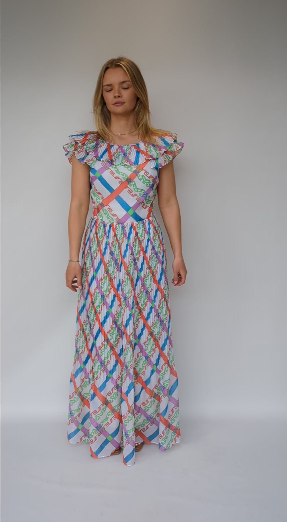 video of vintage 1970s maxi dress with bold pattern of orange, green, blue and purple