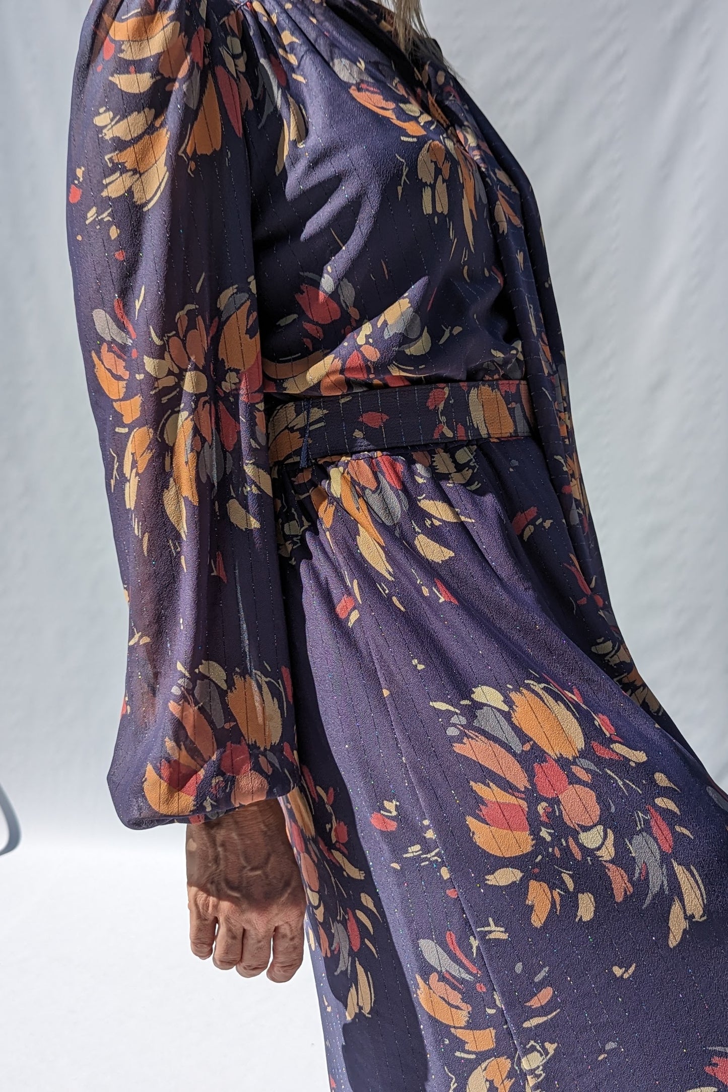 side of vintage floral 80s dress in mauve with an abstract floral pattern of peaches and lilac