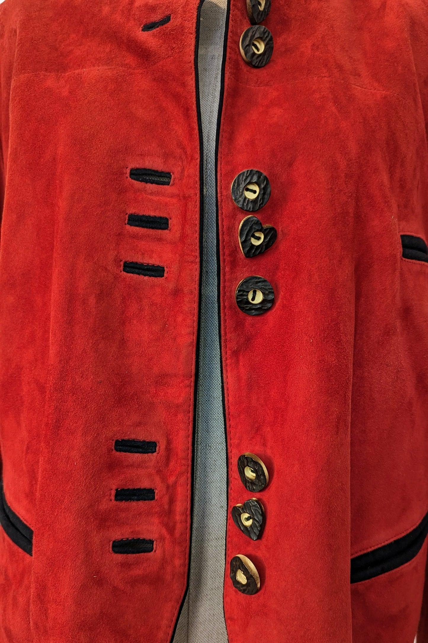 feature heart buttons on red suede jacket