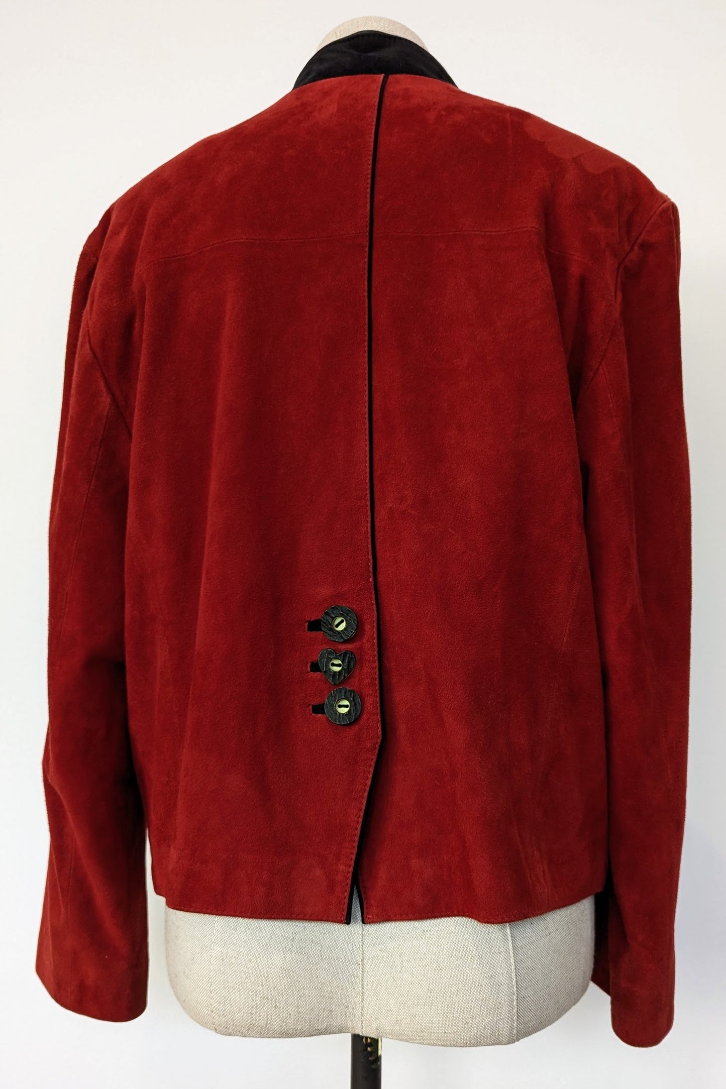 back of red suede jacket with black seam and feature buttons