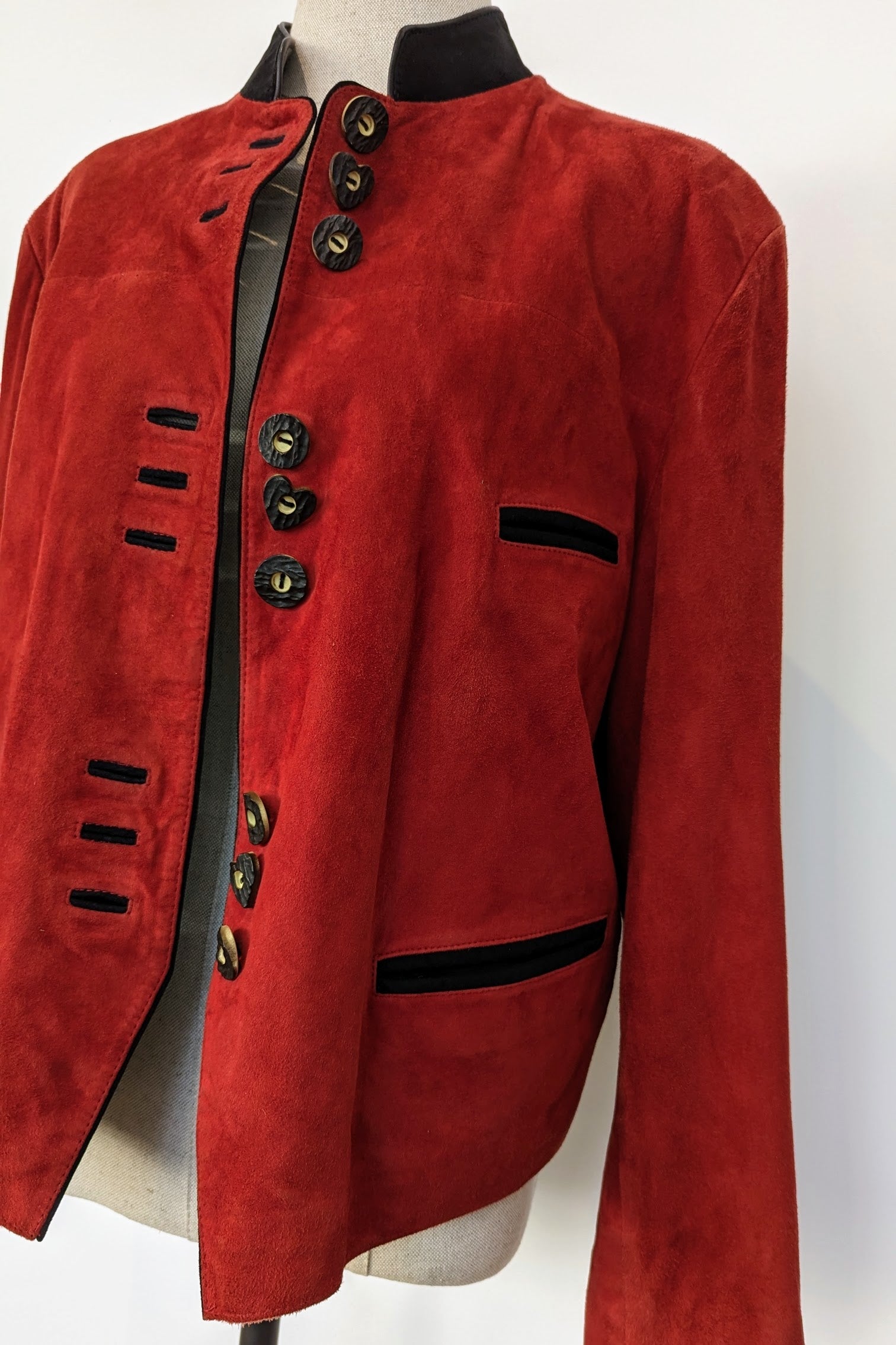 red suede jacket with black trim