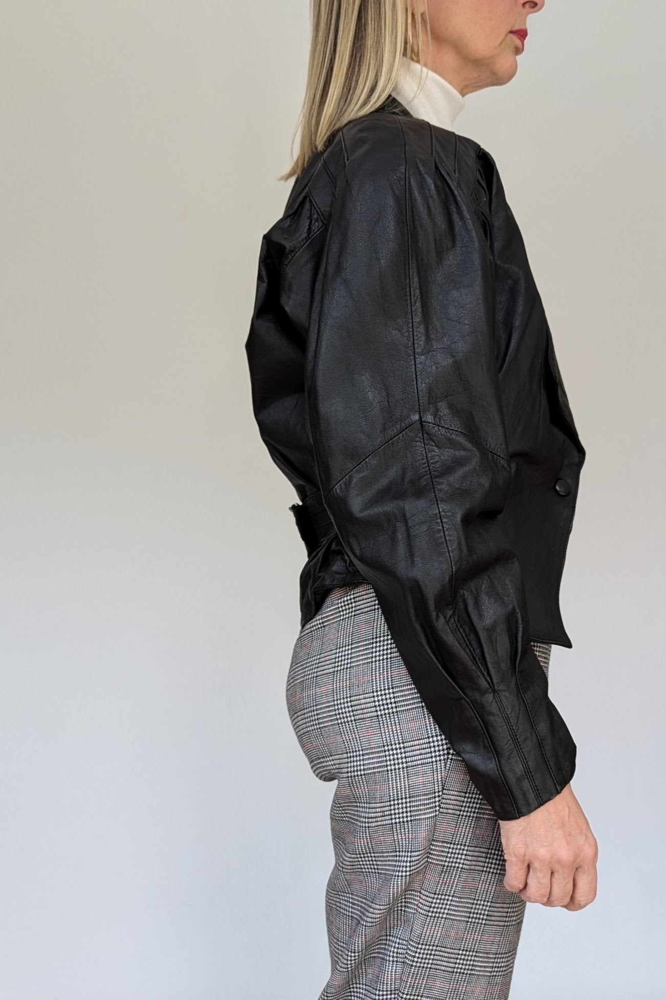 side of short black leather 80s jacket