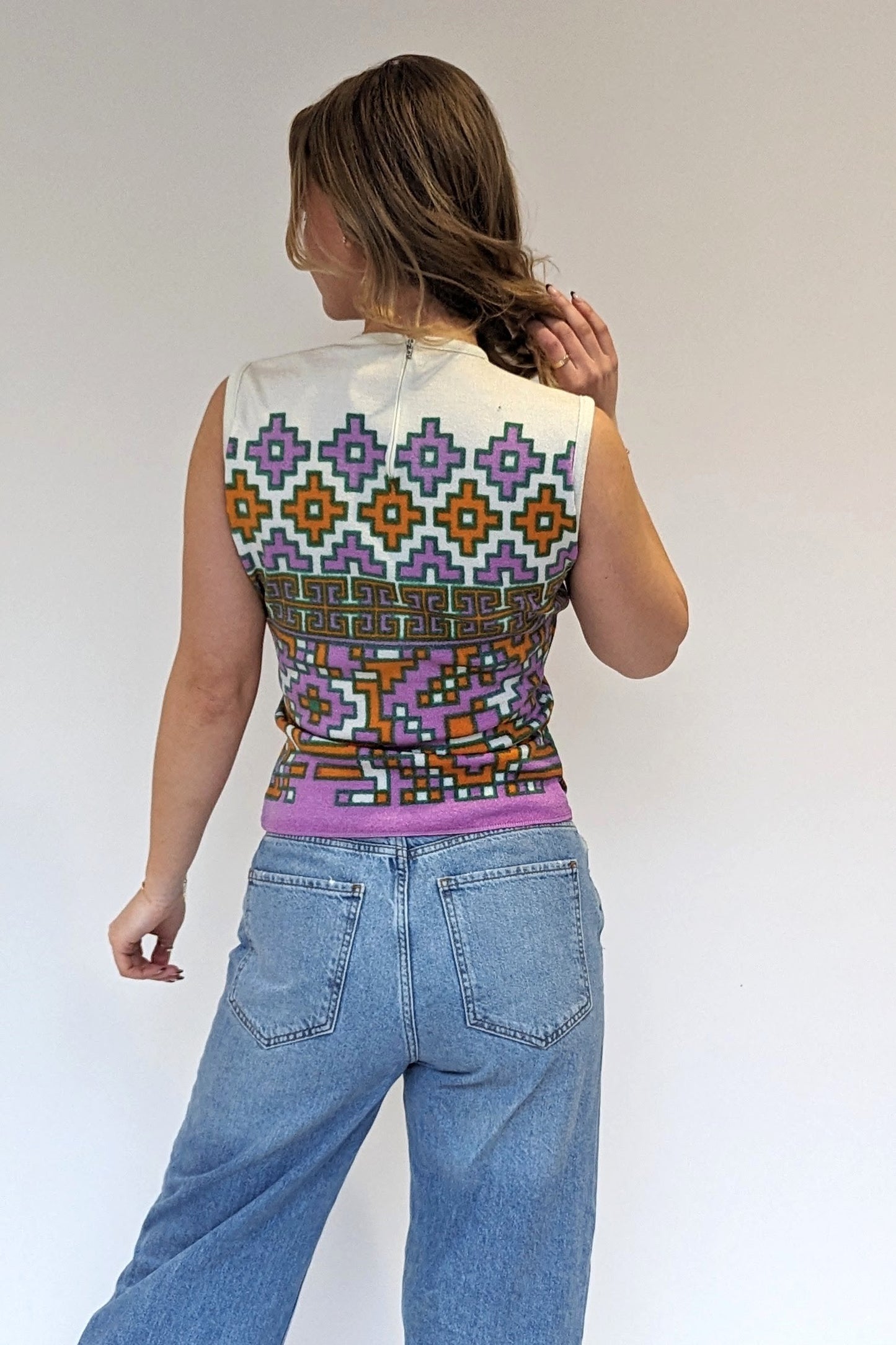 back of 1970s tank top with geometric pattern in green, orange and purple