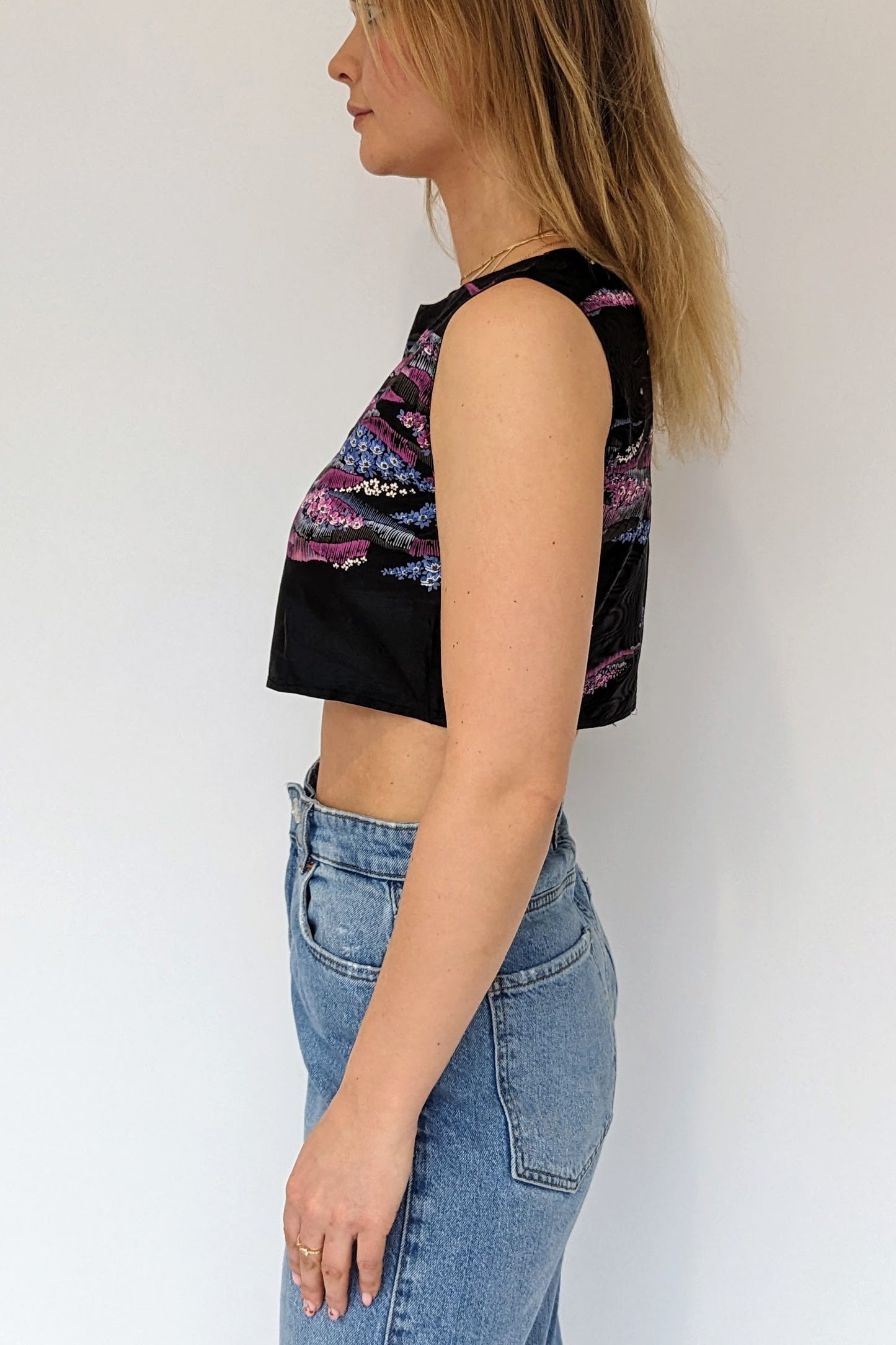 side of vintage black and purple cropped floral top