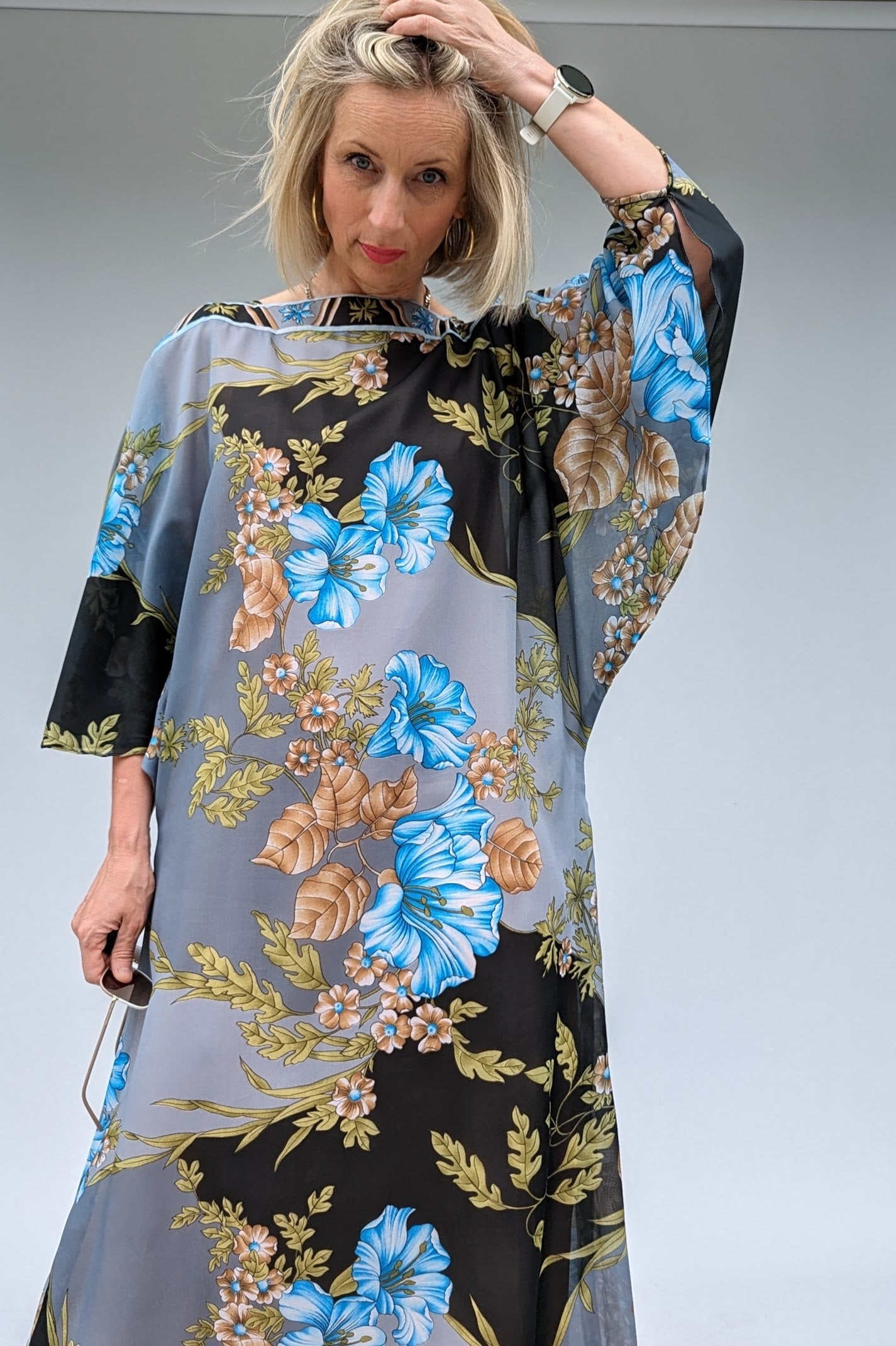 front of Long bat sleeved vintage floral kaftan in grey, black, blue and brown with a sheer overlay and a dusky peach lining