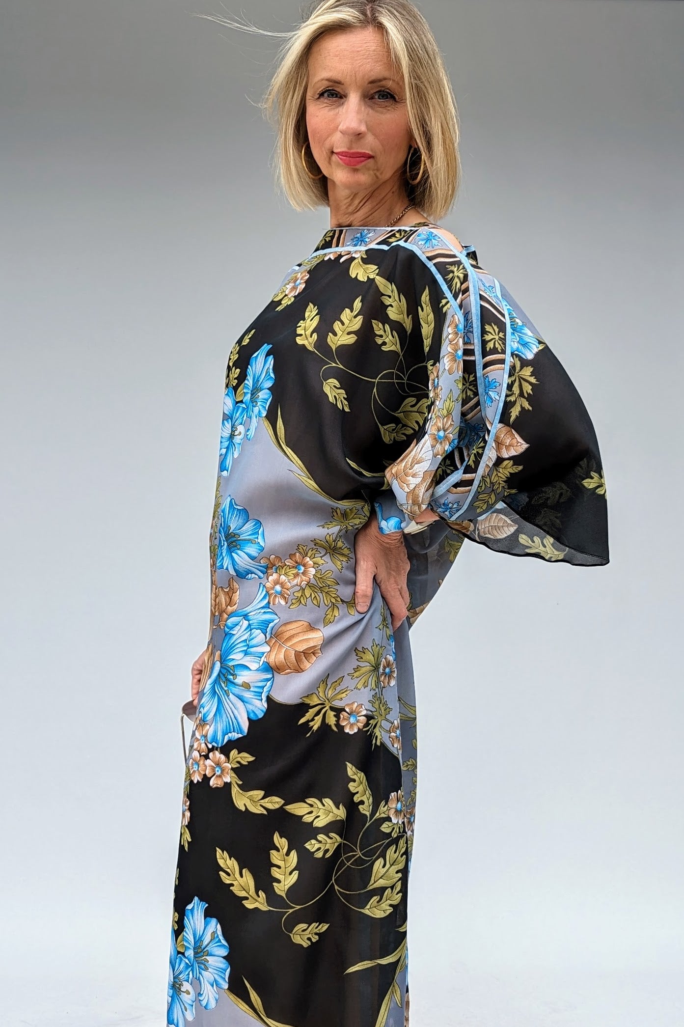 side of Long bat sleeved vintage floral kaftan in grey, black, blue and brown with a sheer overlay and a dusky peach lining