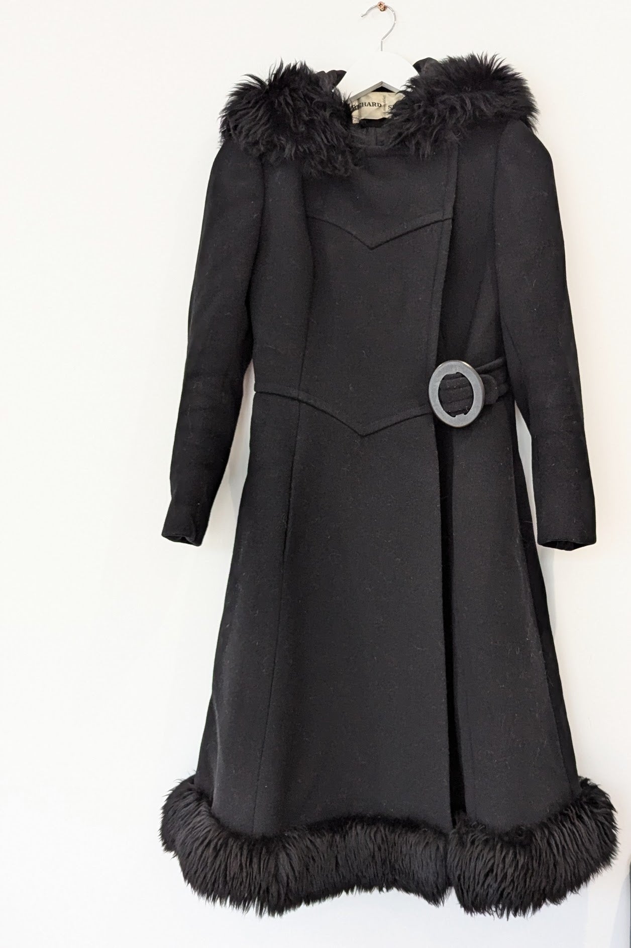 vintage hooded black long winter coat with fur trim and side buckle on hanger118_105347378